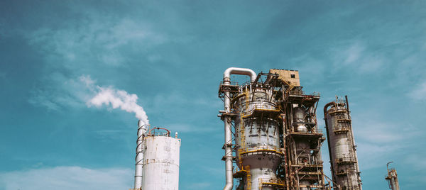 Low angle view of smoke stack against sky