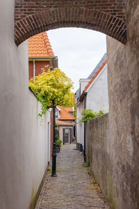 Narrow alley amidst buildings against sky