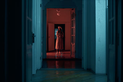 Woman standing by door of building