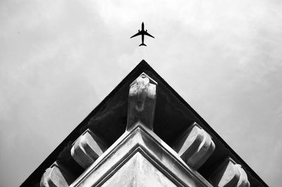 Low angle view of plane  against sky