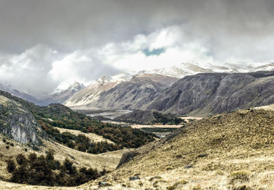 Scenic view of mountains against cloudy sky