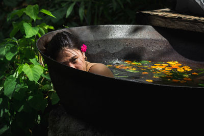 Woman relaxing by potted plant