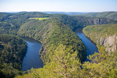 High angle view of river amidst green landscape against sky