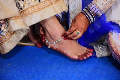 Woman wearing anklet on bride ankle