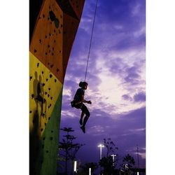 Silhouette of woman standing against sky