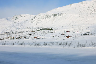 Scenic view of snow covered mountains against sky