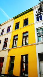 Low angle view of yellow building against clear sky