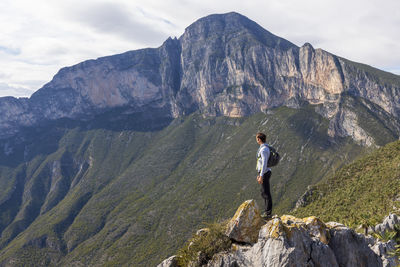 Rear view of man standing on mountain