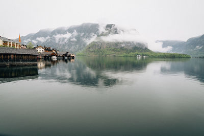 Scenic view of lake with houses in background