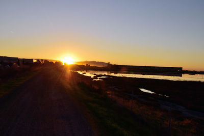 Scenic view of road against sky during sunset