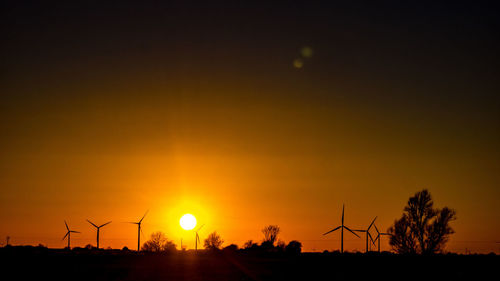 Silhouette of windmill at sunset