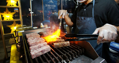 Man preparing food on barbecue grill