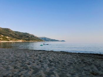 Scenic view of beach against clear sky