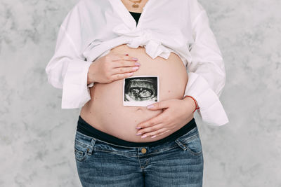 Midsection of woman holding paper currency