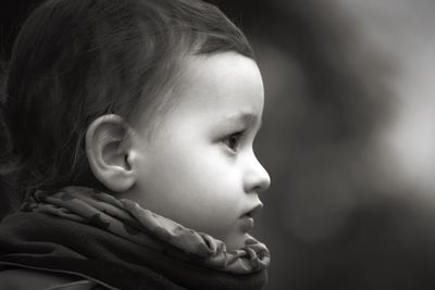 Close-up of cute baby girl looking away