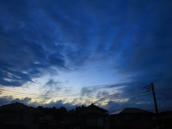 Low angle view of silhouette buildings against sky at sunset