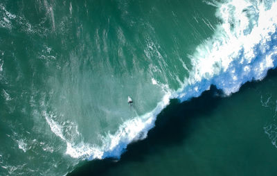 High angle view of man with surfboard on sea