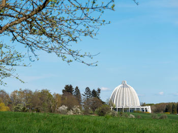 Built structure on field against sky