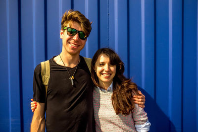 Portrait of smiling young couple standing outdoors