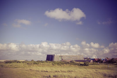 Built structure on field against sky