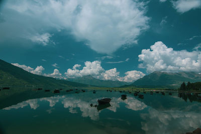 Scenic view of lake and mountains against sky