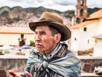 Portrait of man wearing hat looking away