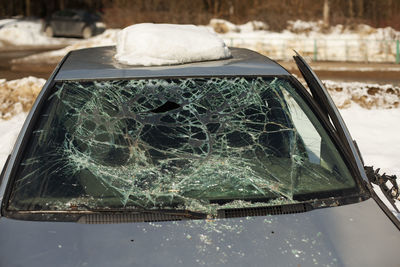 Broken car glass. cracks on windshield. car after accident. lots of trawls on window.