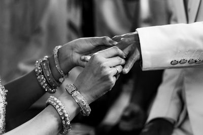 Midsection of couple holding hands