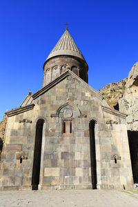 Low angle view of historic building against blue sky