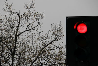 Low angle view of road signal against sky