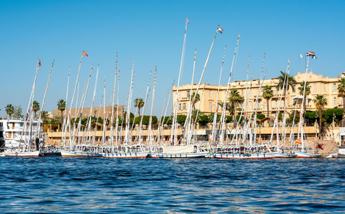 Sailboats in sea against clear sky