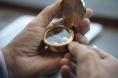 Businessman using navigational compass at cafe