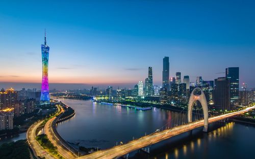 Illuminated buildings in city against sky