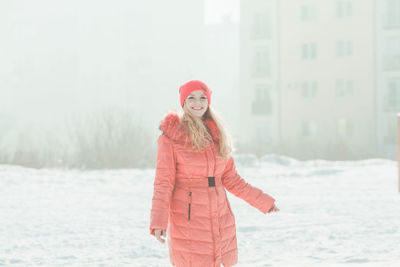 Woman standing on snow covered landscape during winter