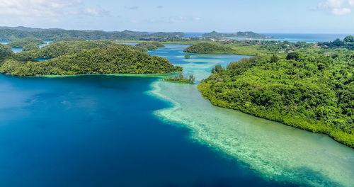 Aerial view of blue lagoon by sea against sky