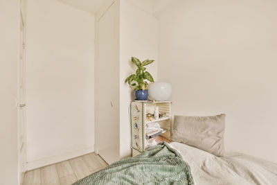 Portrait of woman sitting on bed at home