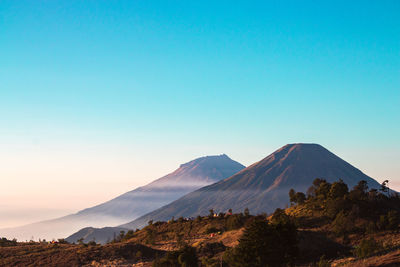 Scenic view of mountains against clear blue sky