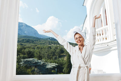 Cheerful woman in bathrobe