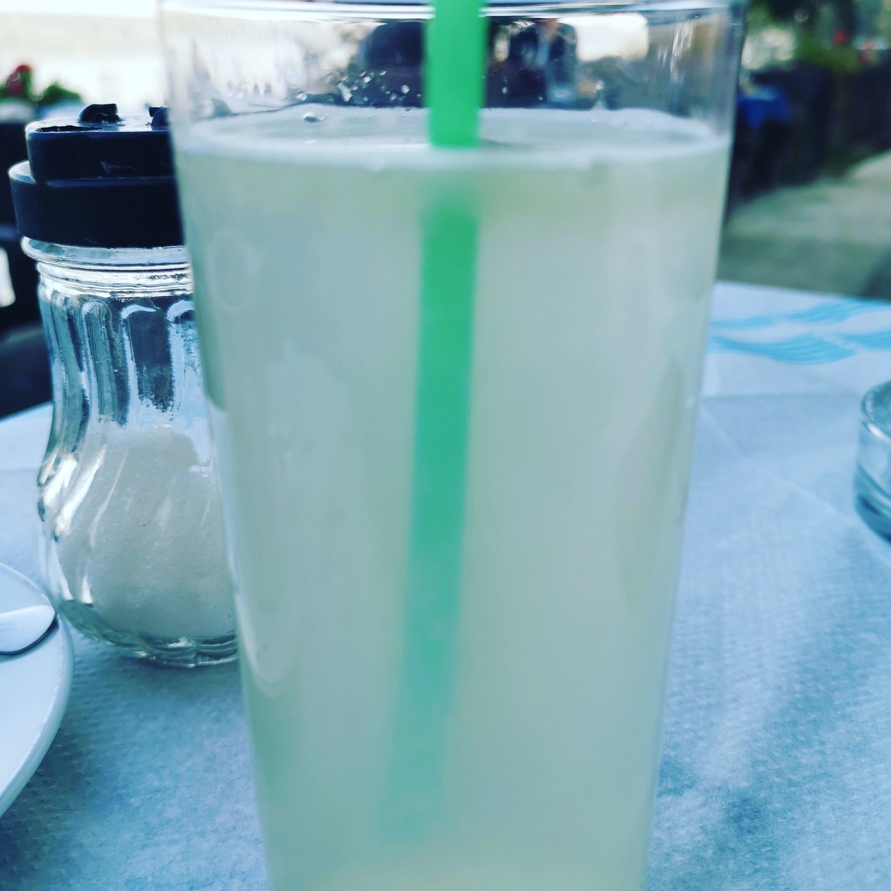 CLOSE-UP OF BEER GLASS ON TABLE