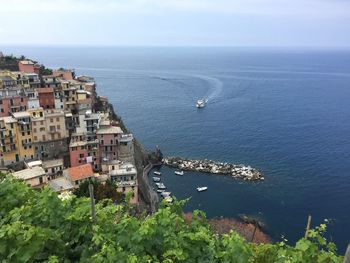 High angle view of townscape by sea against sky