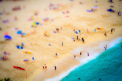 Tilt-shift image of people at beach