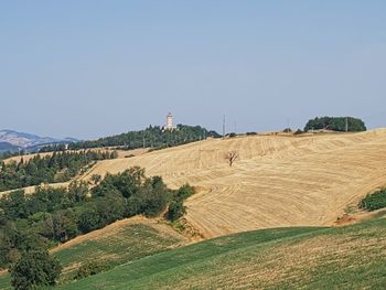 Scenic view of farm against clear sky