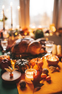 Thanksgiving holiday dinner table setting with fall decoration and pumpkins