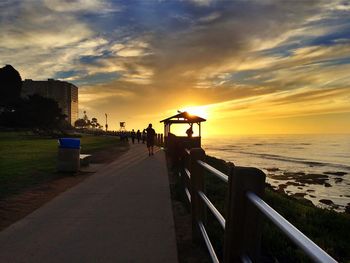 Pier on sea at sunset