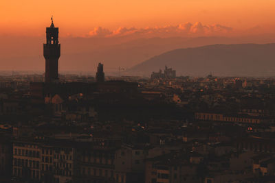 Buildings in city at sunset