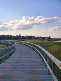 Boardwalk on field against sky at the bouctouche dune