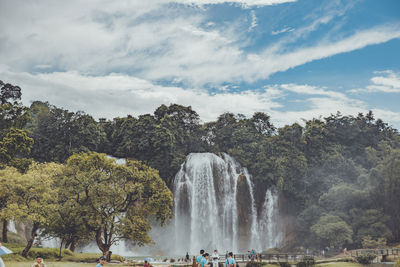 Scenic view of waterfall against sky