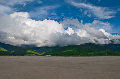 Scenic view of road and mountains against sky