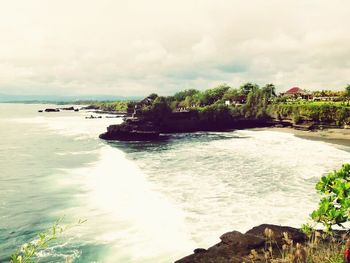 Scenic view of sea against cloudy sky
