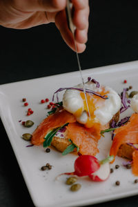 Close-up of person holding food on table